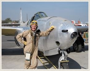 A man standing next to a plane.